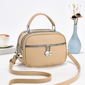 Chic apricot lychee leather multi-zip crossbody bag with top handle and adjustable strap