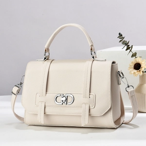 Litchi pattern cream handbag with silver buckle on minimalist stone pedestal