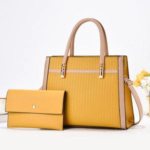 Close-up of bright yellow two-piece tote set with geometric texture and gold hardware