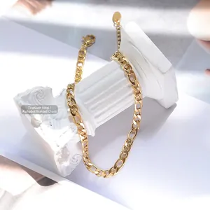 Polished titanium steel Figaro chain anklet with golden finish on a white pedestal