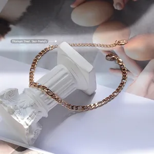 Minimalist thick chain anklet in rose gold titanium steel on a white roman pillar stand