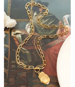 Macro view of gold-plated double-layer necklace with lava pendant on oil painting