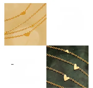 Close-up of 18K gold plated titanium steel necklace with small heart-shaped pendants