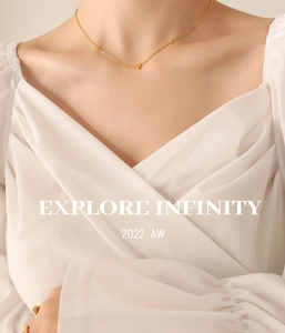 Close-up of minimalist gold titanium steel necklace with heart pendants on neck