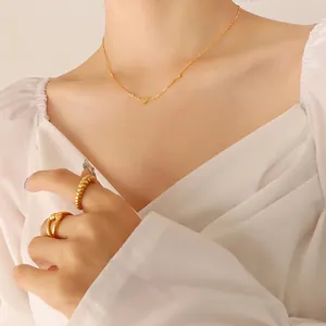 Minimalist gold heart pendant necklace with twisted rope and smooth band rings set