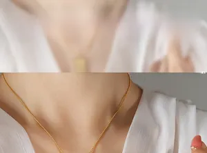Detailed model shot of a minimalist gold beaded chain necklace with elegant metallic shine