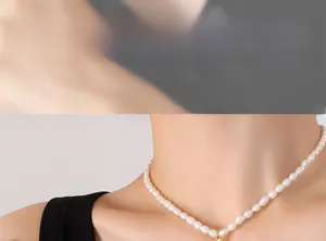 Detail of freshwater pearl necklace with 18K gold moon pendant on a female model