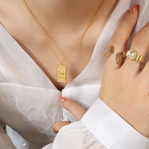 Golden double-sided Venus 1996 portrait pendant necklace and butterfly ring set on model