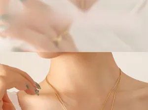 Close-up of double layer gold snake chain necklace on model's neck for elegant styling