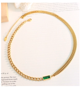 Close-up of gold chain necklace featuring a rectangular green zircon and 18K stamp detail