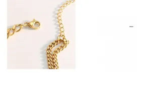 Detailed macro view of the gold-plated chain links with secure lobster clasp and extender