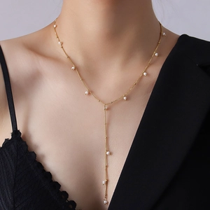 Elegant gold Y-shaped tassel necklace with freshwater pearls for women on model