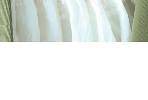 Close-up of a green twill jacket paired with a white lace inner garment for women