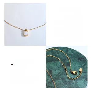 Detail of 18K gold-plated stainless steel necklace featuring a white shell square pendant