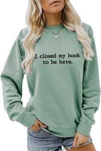 Detail of the black letter slogan print on mint green cotton sweatshirt fabric