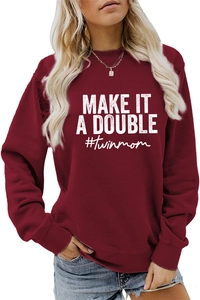 Close-up of MAKE IT A DOUBLE and #twinmom white print on a wine red sweatshirt