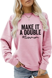 Detail view of pink crewneck sweatshirt with black MAKE IT A DOUBLE print and ribbed cuffs