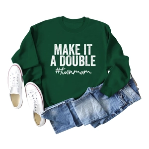 Flat lay of dark green sweatshirt with white Make It A Double print and denim jeans