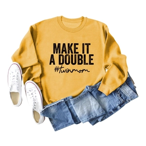 Flat lay of yellow 'Make It A Double' sweatshirt with denim jeans and white sneakers