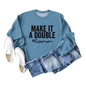 Blue crewneck sweatshirt with Make It A Double print paired with jeans and shoes
