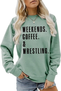 Detail of green crewneck sweatshirt with black Weekends Coffee wrestling text print