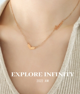 Close-up of rose gold Love heart pendant and Lover script necklace on a model