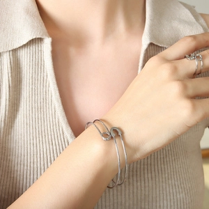 Adjustable silver safety pin jewelry set with polished open bangle and matching ring