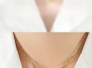 Detail of gold double-layered necklace featuring a box chain and dainty bead chain style