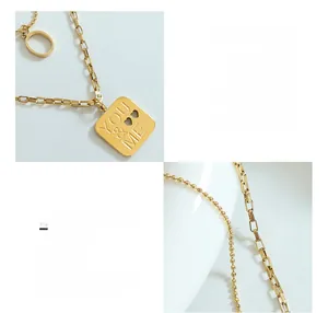 Detail of 18K gold-plated titanium steel necklace with YOU & ME engraved square pendant