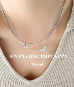 Close-up of double-layered silver heart necklace with Lover pendant on a model