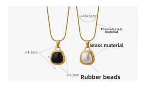 Detailed view of square black and white pendants with dimensions on a snake chain