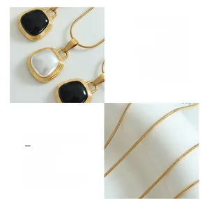 Detail of 18K gold plated snake chain with black and white square bead pendants