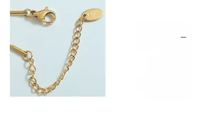 Detail of 18K gold plated extension chain with lobster clasp and K18 hallmark tag