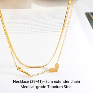 Double-layered gold heart necklace made of medical-grade titanium steel on book