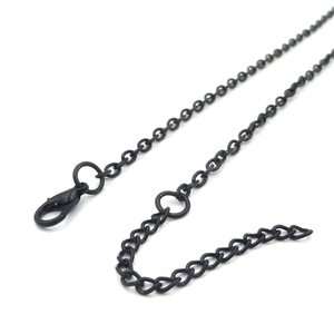 Detailed view of matte black necklace chain with lobster clasp and extension links