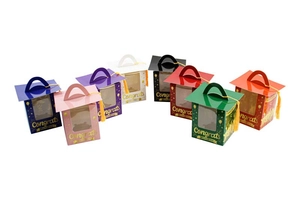 Detail of graduation cupcake boxes in eight colors with mortarboard lids and gold tassels