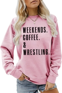 Detailed view of pink crewneck sweatshirt featuring black WEEKENDS COFFEE WRESTLING print