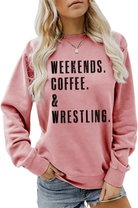 Detail of pink crewneck sweatshirt featuring bold black Weekends Coffee printed text