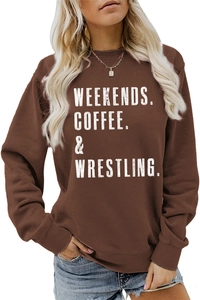 Close-up of Weekends Coffee & Wrestling slogan print on dark brown crewneck sweatshirt