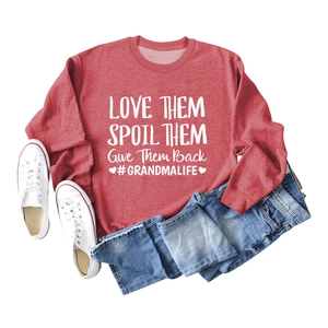 Vue à plat d'un sweat rouge à manches longues avec slogan blanc 'Love Them Spoil Them'