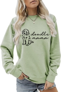 Détail du sweat-shirt vert clair avec texte doodle mama et imprimé silhouette de chien