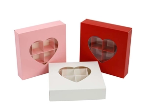 Detail of pink and red chocolate gift boxes with heart window and 6 compartment dividers
