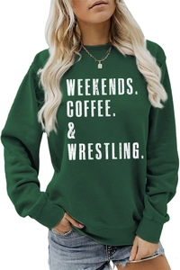 Detail of white text print on a dark green crewneck sweatshirt with ribbed cuffs