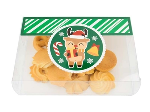 Macro view of transparent PVC Christmas cookie box with reindeer motifs and green seal