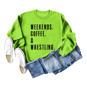 Detail of ribbed cuffs and collar on lime green sweatshirt with black text print