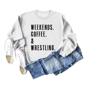 Flat lay of light grey sweatshirt with black letter print and casual fashion accessories