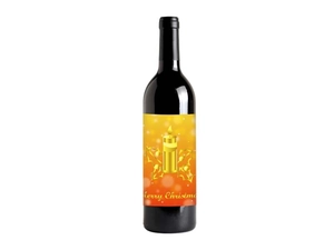 Close-up of gold foil Merry Christmas wine label with candle design on a bottle
