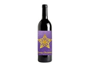 Detail of custom gold foil wine label with Merry Christmas logo on purple matte paper