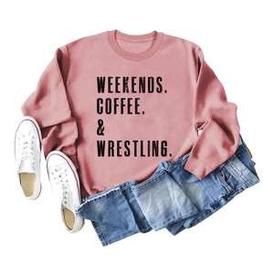 Pink crewneck sweatshirt with Weekends Coffee print styled with denim shorts