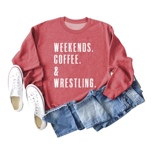 Flat lay of red sweatshirt with Weekends Coffee print and denim shorts for autumn style